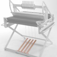 photograph showing four treadles, an add on kit for an Ashford table loom stand